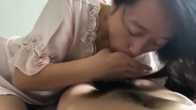 Asian girl gives an enthusiastic blowjob